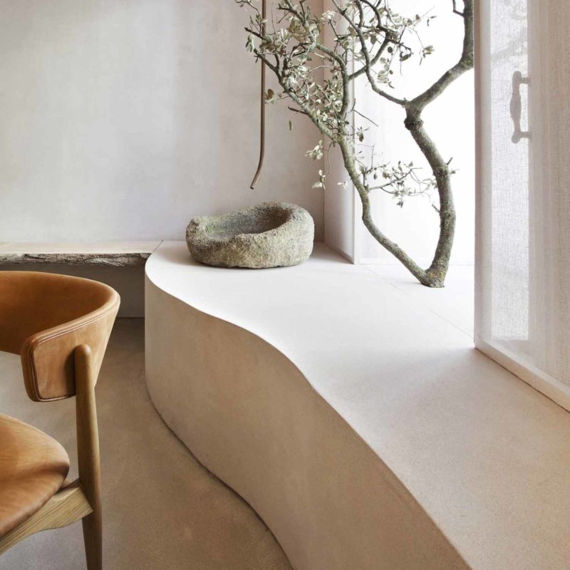 Wabi sabi interior design with stone timber and indoor tree